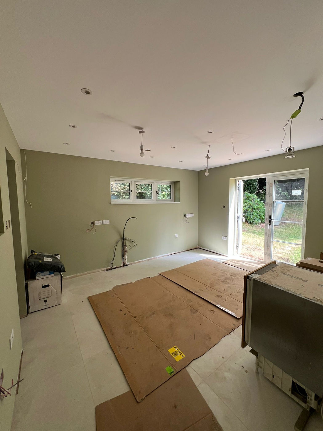 Open-plan kitchen and living room being prepared for finishing work