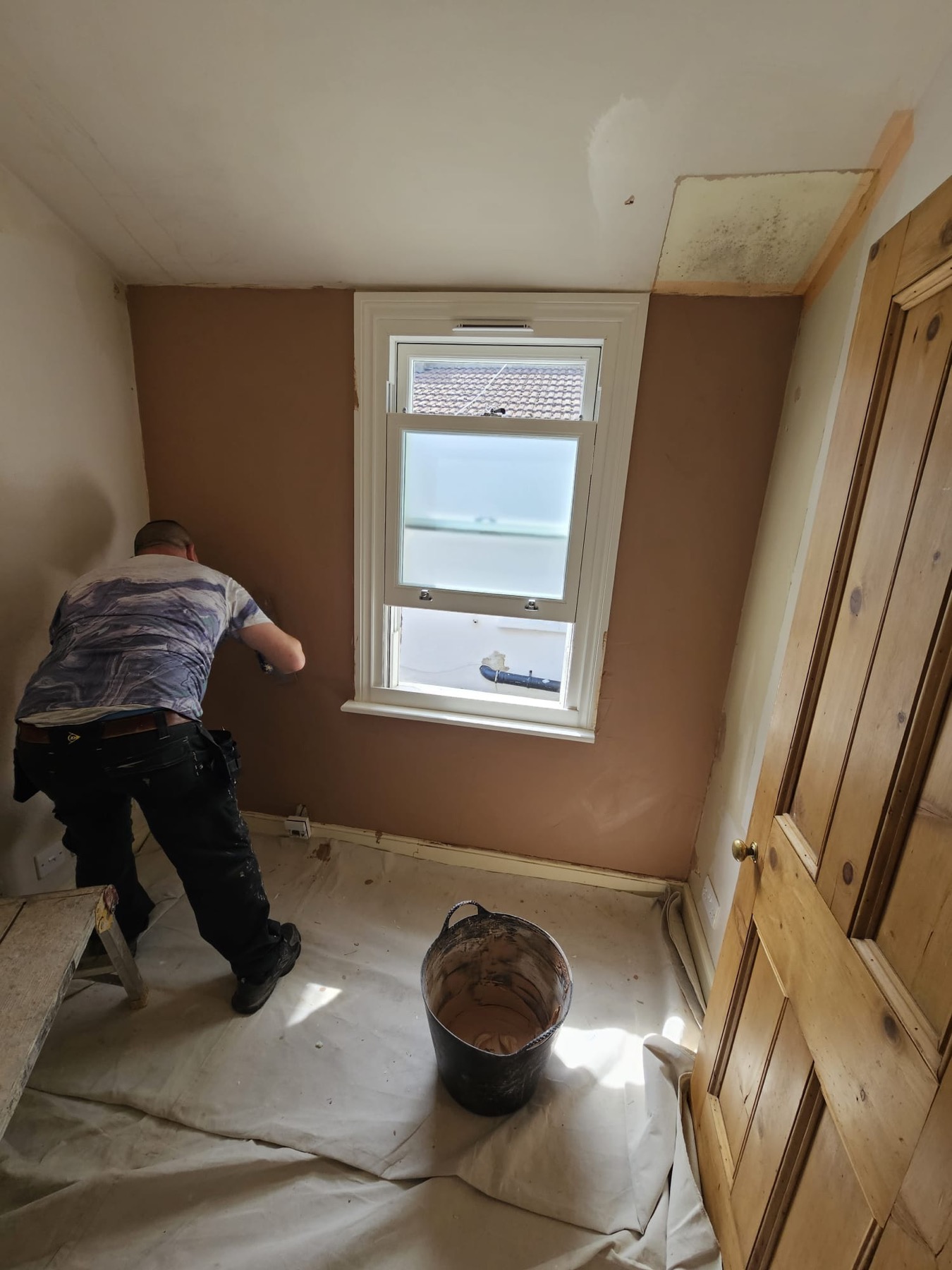 Room wall preparation and repair around a window before decorating